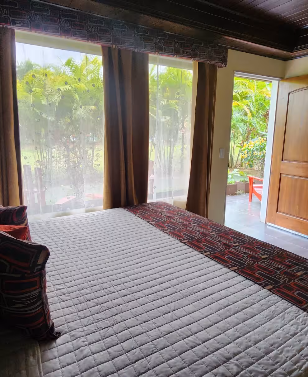 Bright, comfortable hotel room with volcano view